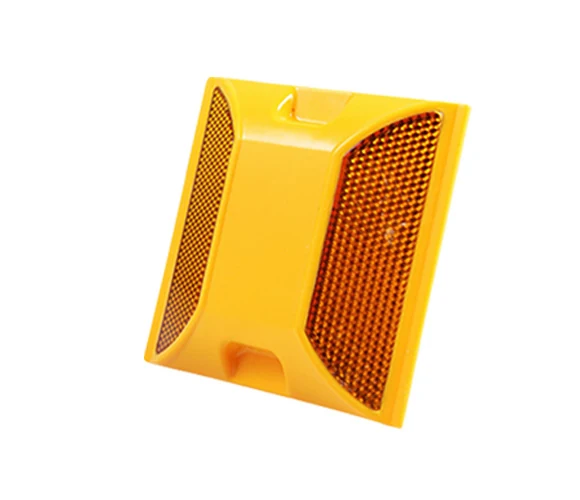 Yellow plastic road stud with two reflective faces